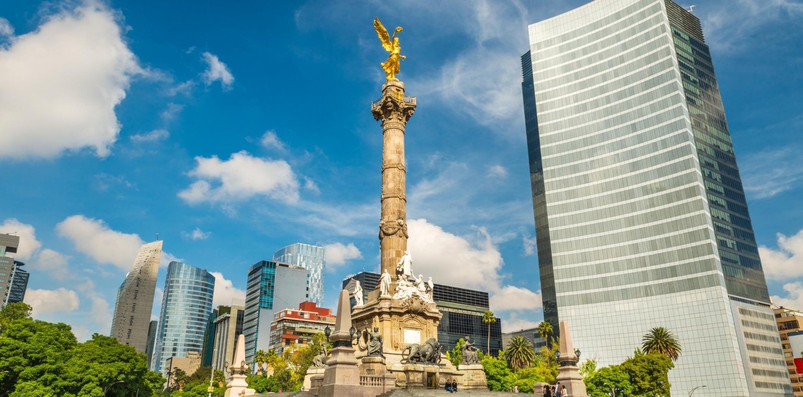 a statue in front of a city
